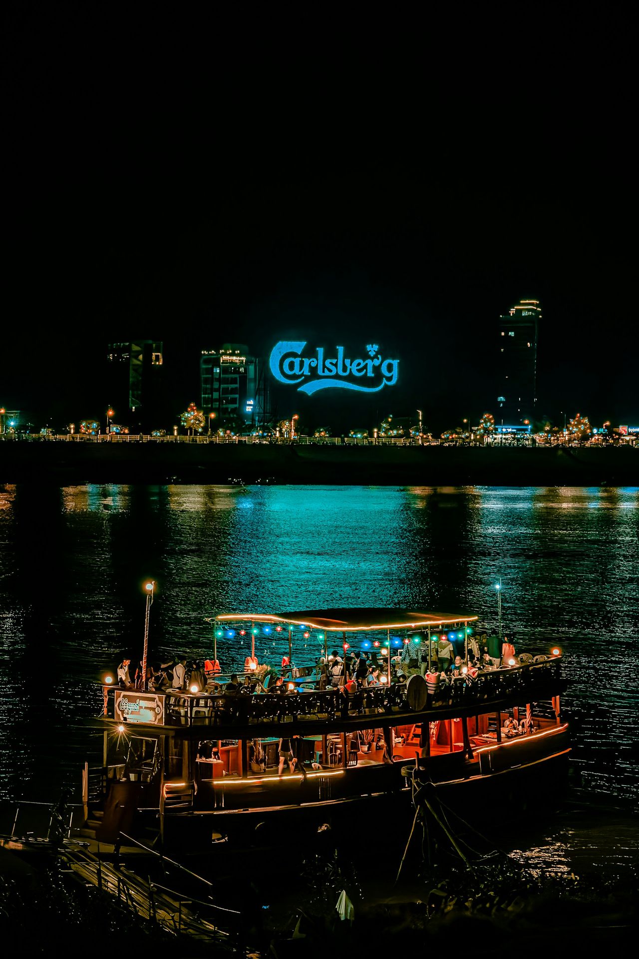 a boat with people on it floating in the water